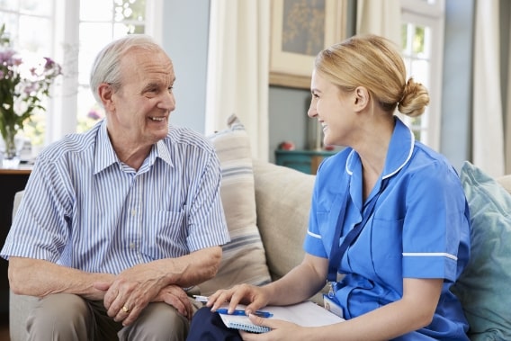 Female nurse visits elderly man