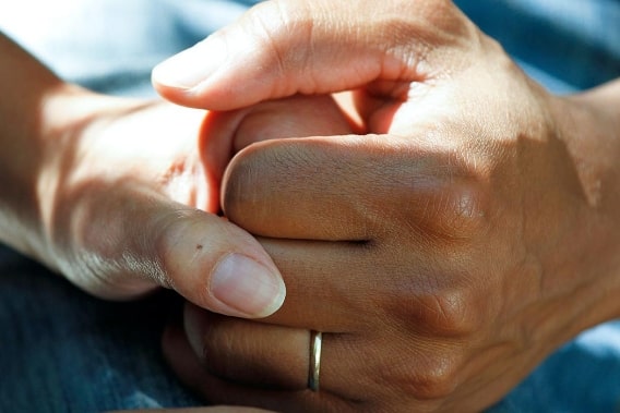 Couple holding hands for comfort